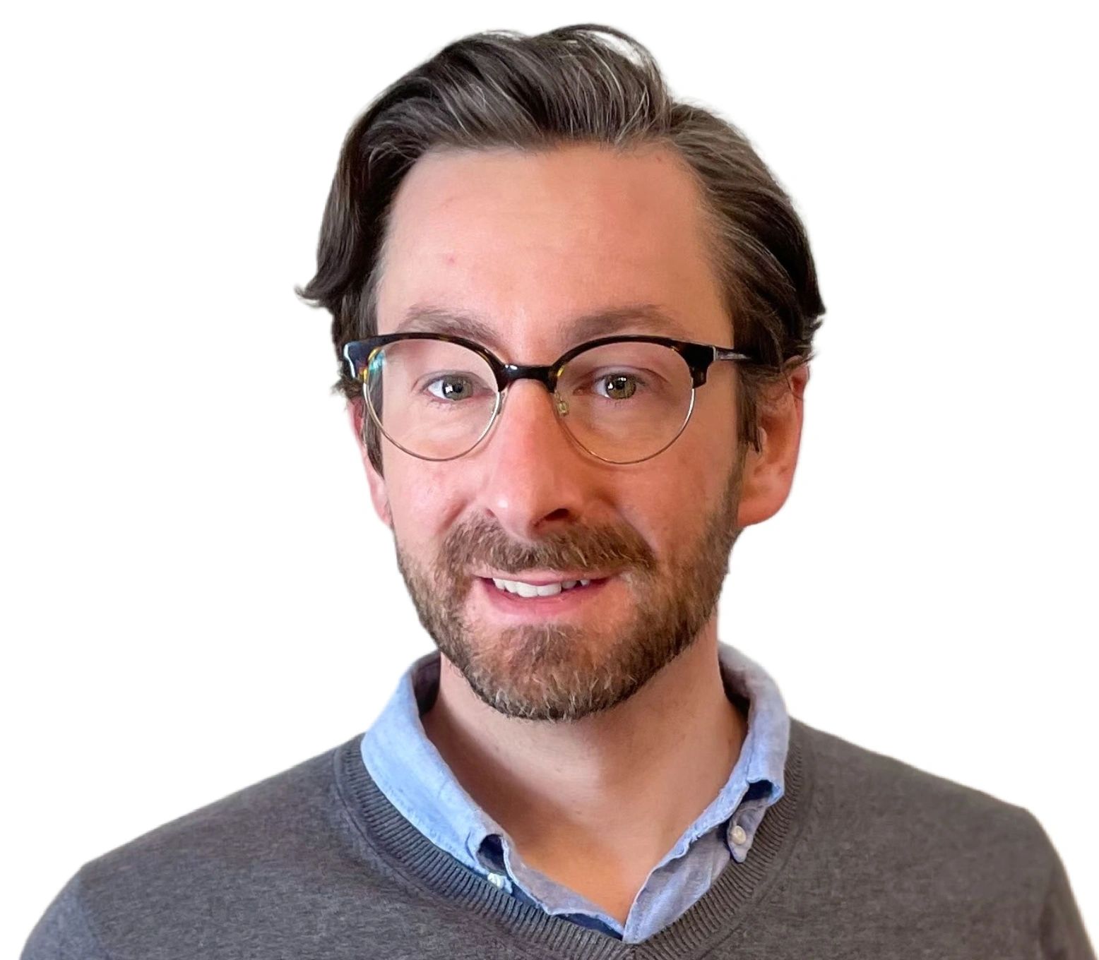Man with glasses, beard, and casual shirt smiling.